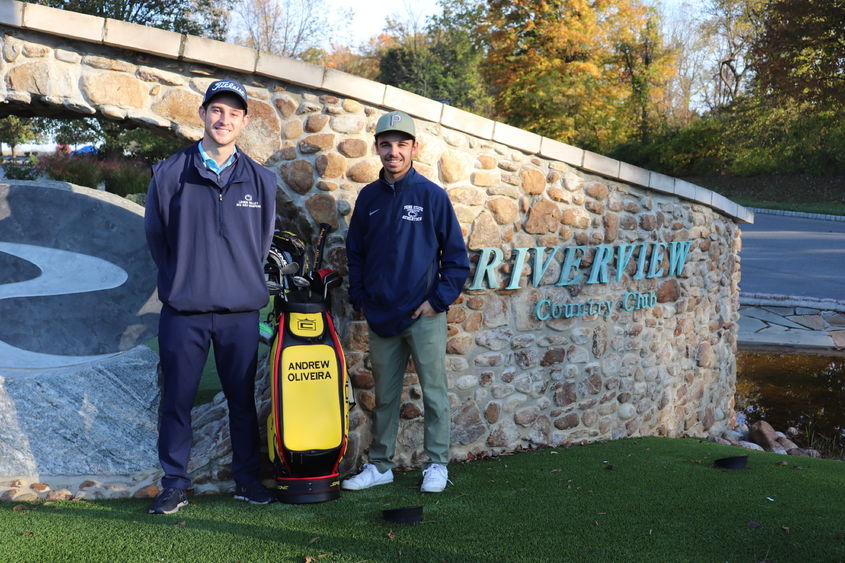 Two men outside country club wall