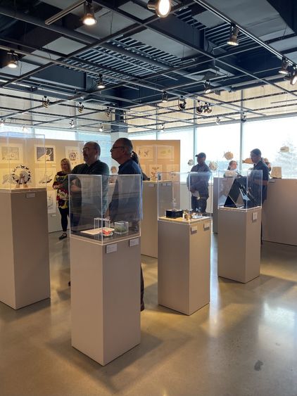 Art exhibit visitors check out works on display.