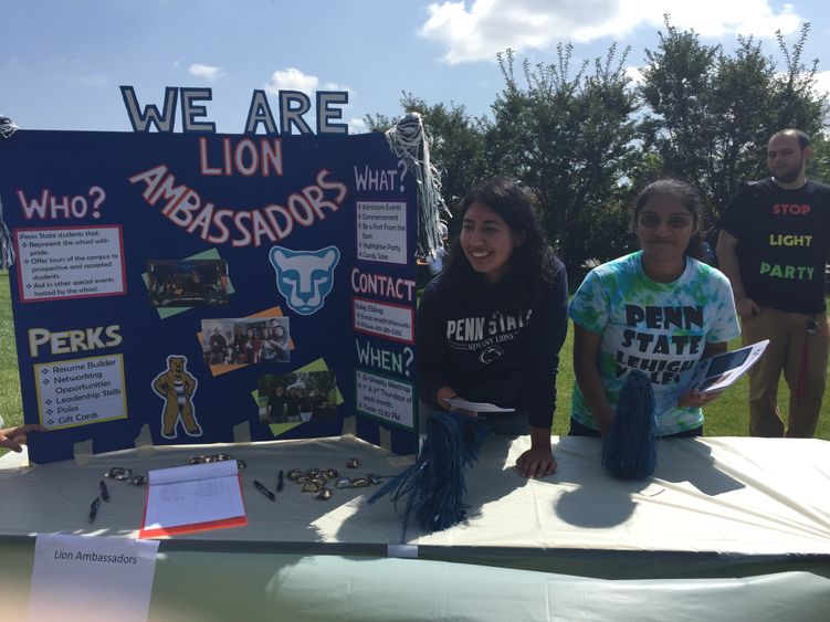 Two students staffing the Lion Ambassadors table