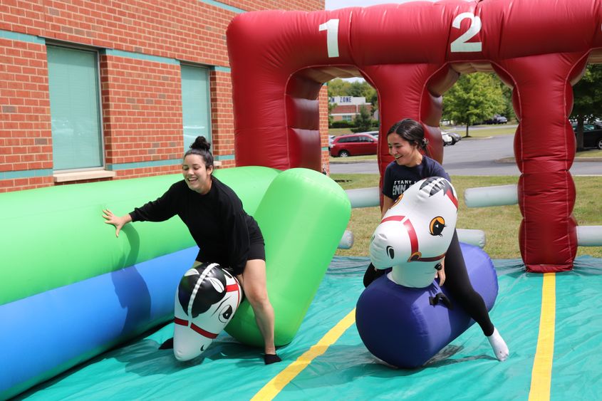 two young women riding inflatable horses