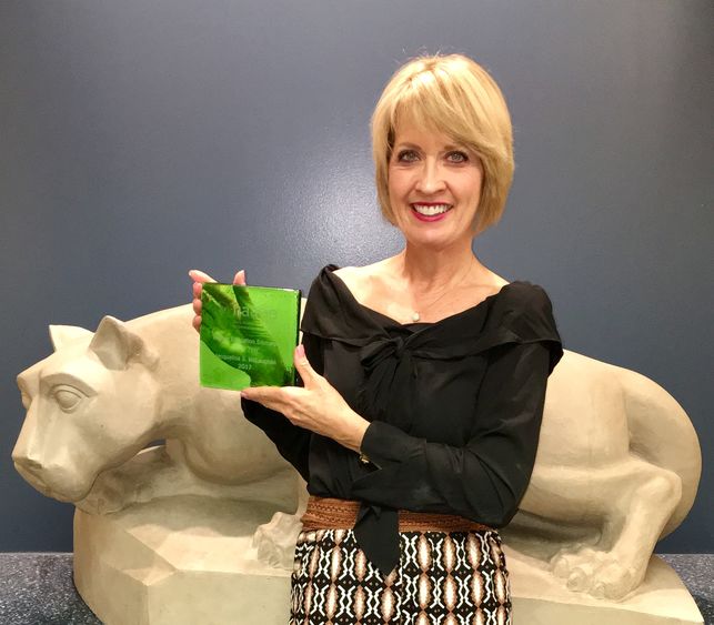 Professor McLaughlin holding her award