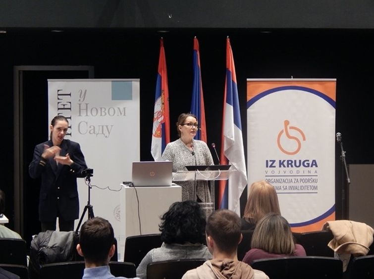 A woman giving a presentation at a podium