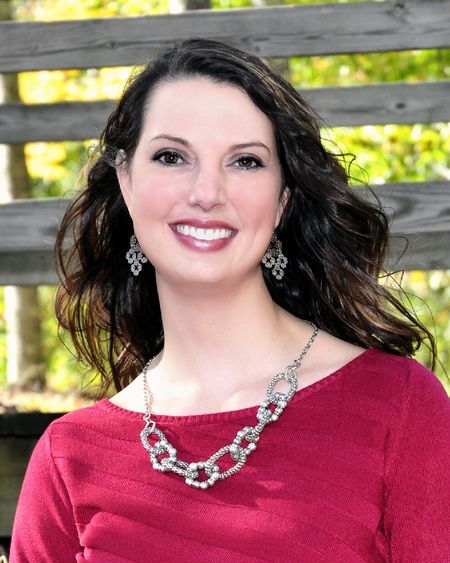 head shot of woman with brown hair and red shirt