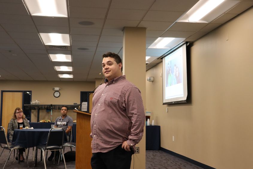 man speaking at front of the room