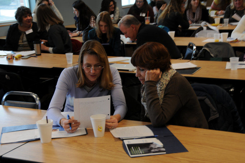 two women working on a paper