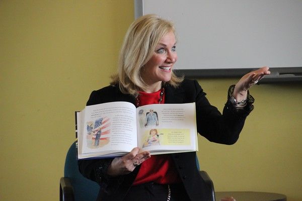 Woman reading a book at public event