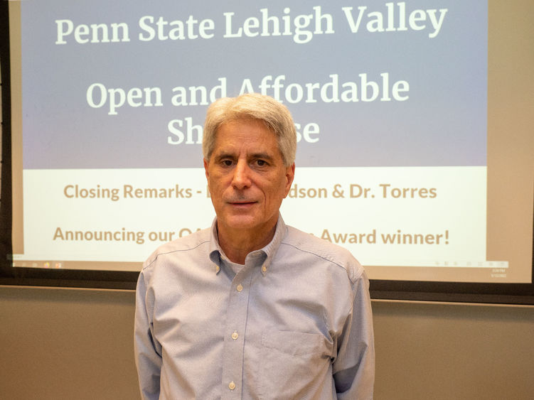 PSU-LV Lecturer Larry Musolino poses for camera after winning award. 
