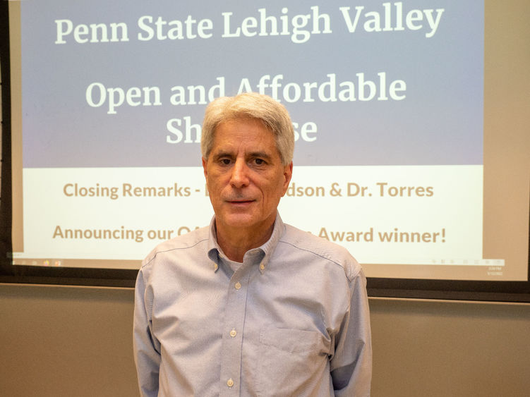 PSU-LV Lecturer Larry Musolino poses for camera after winning award.