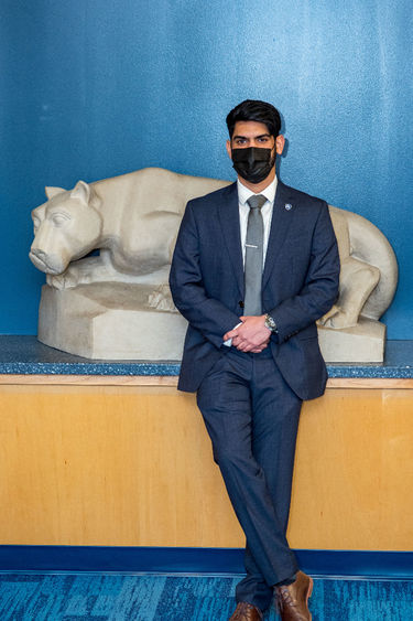 Previn Joseph standing by Nittany Lion sculpture 