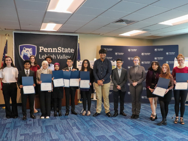 Students posing with awards