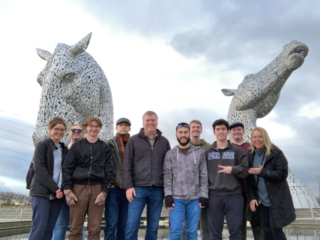A group of eight students and two faculty advisors standing in front of “The Kelpies”