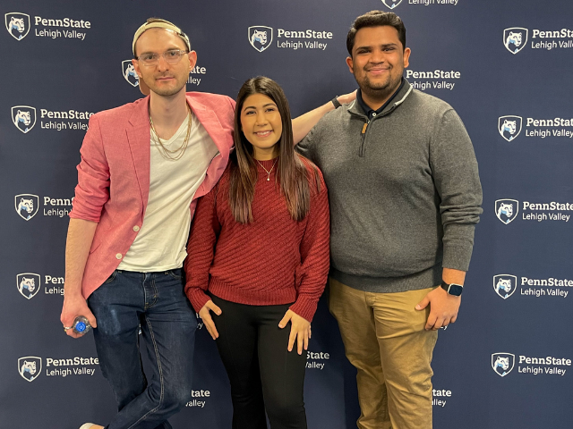 PSU-LV Alumni Standing in front of back drop