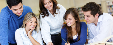 group of professionals leaning over desk