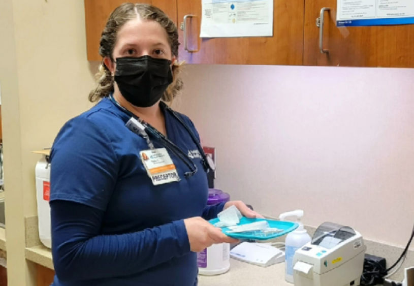 Taylor Argeson stands in exam room
