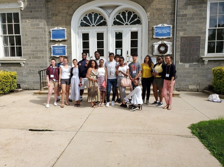 A group of high school student in front of a courthouse