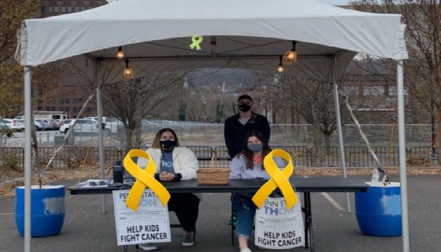 Students staffing a table at Christkindlmarkt