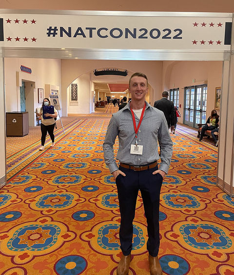 Trevor Faust stands at veterans conference