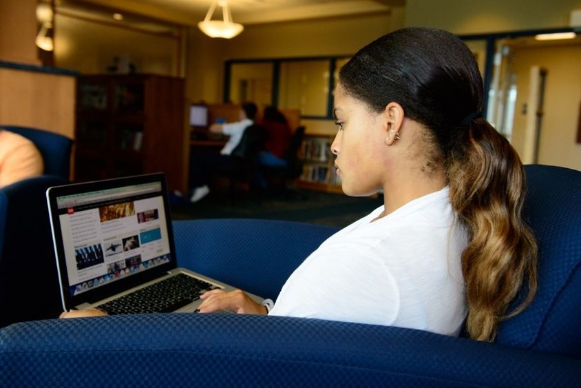 woman at laptop in library