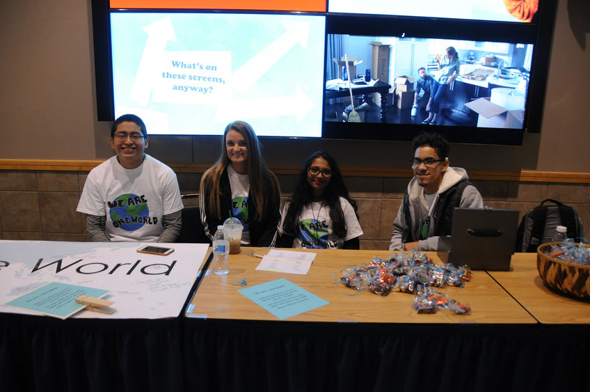 Students staffing a table Students staffing a table
