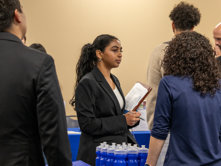 a female student speaking with an employer 