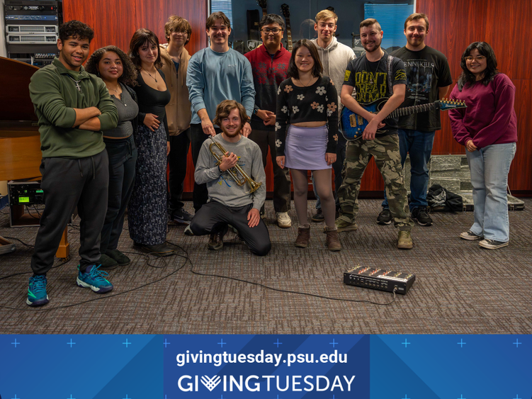 a group of students smile in a room full of instruments