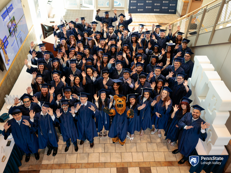 Penn State Lehigh Valley grads smile with the nittany lion on commencement day